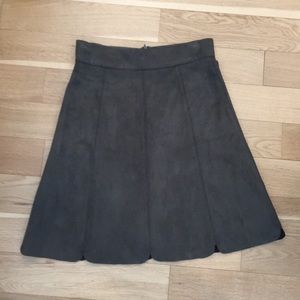 Green suede scalloped, knee-length skirt.